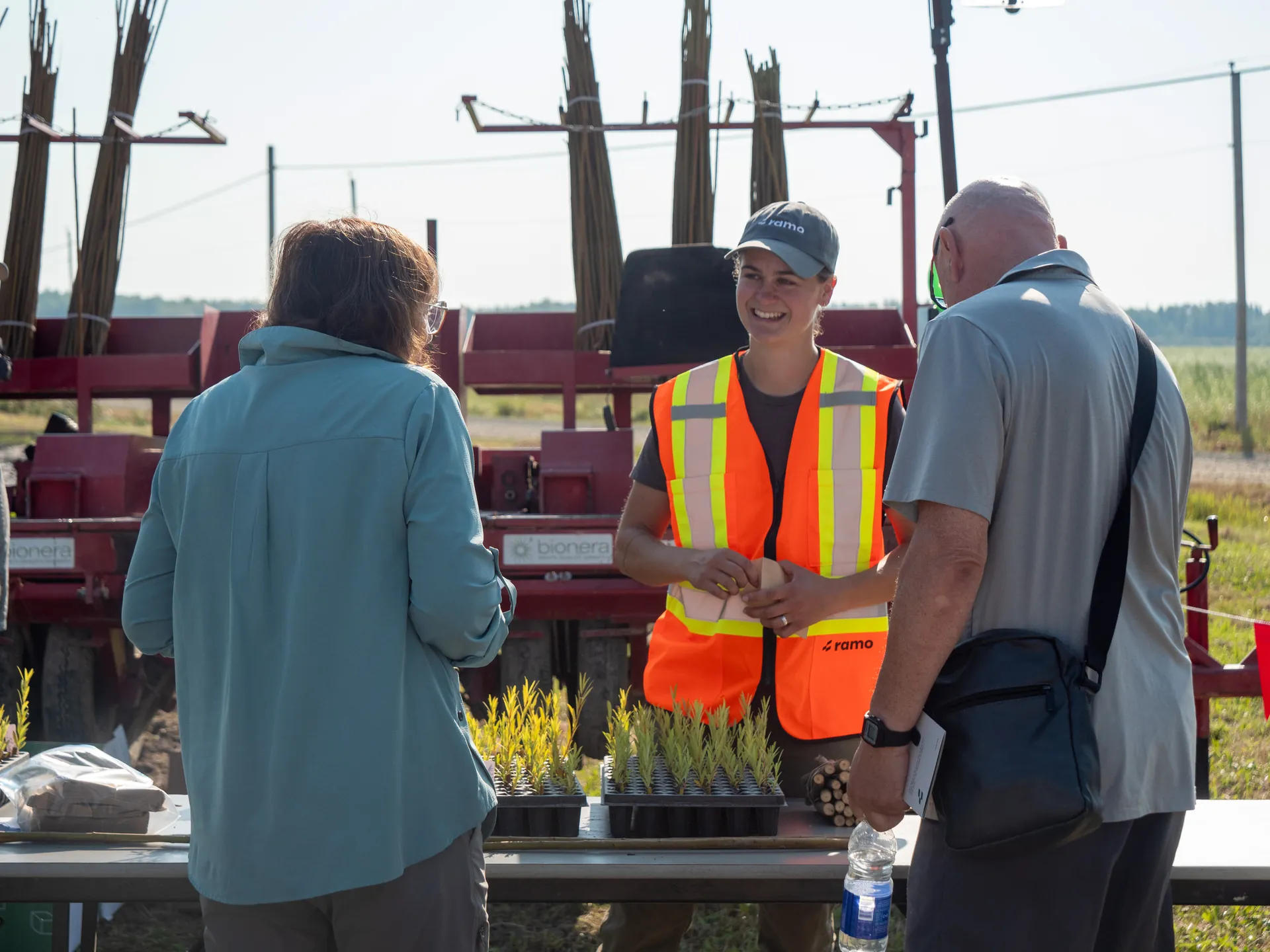 A Ramo team member talking with visitors during a planting demonstration