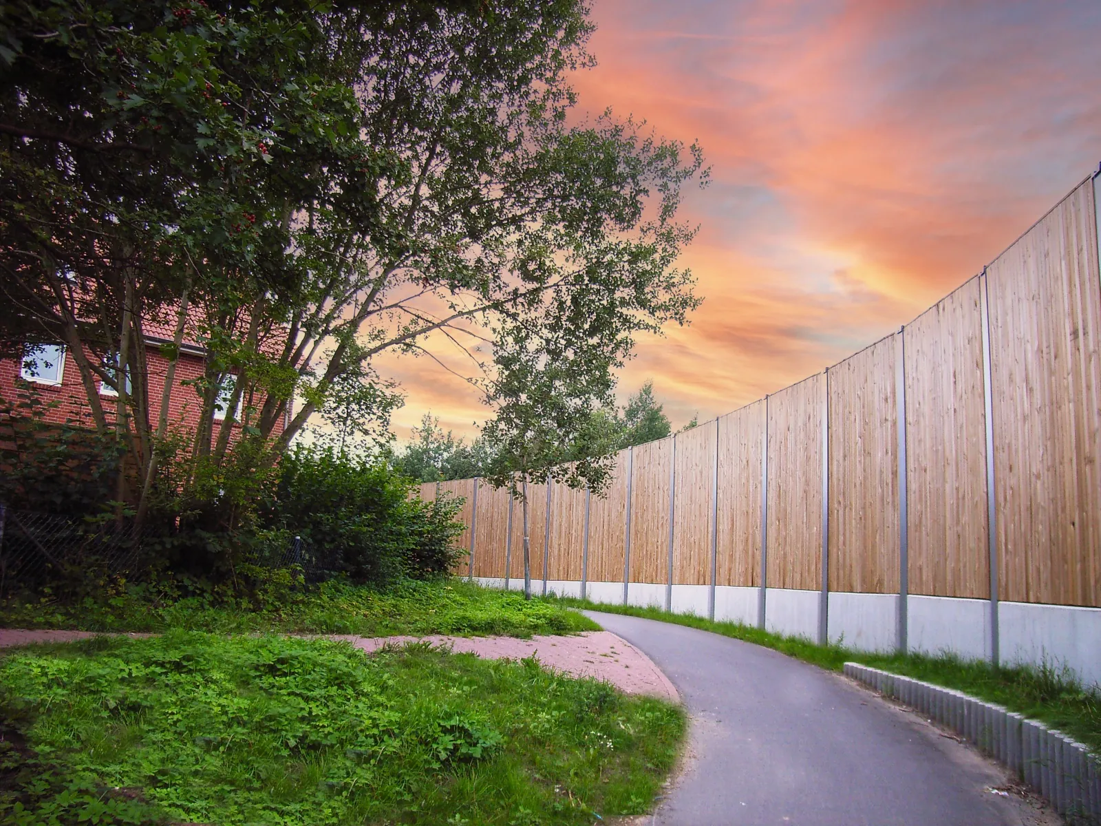 Écran acoustique HF1 le long d'un sentier piéton au coucher du soleil